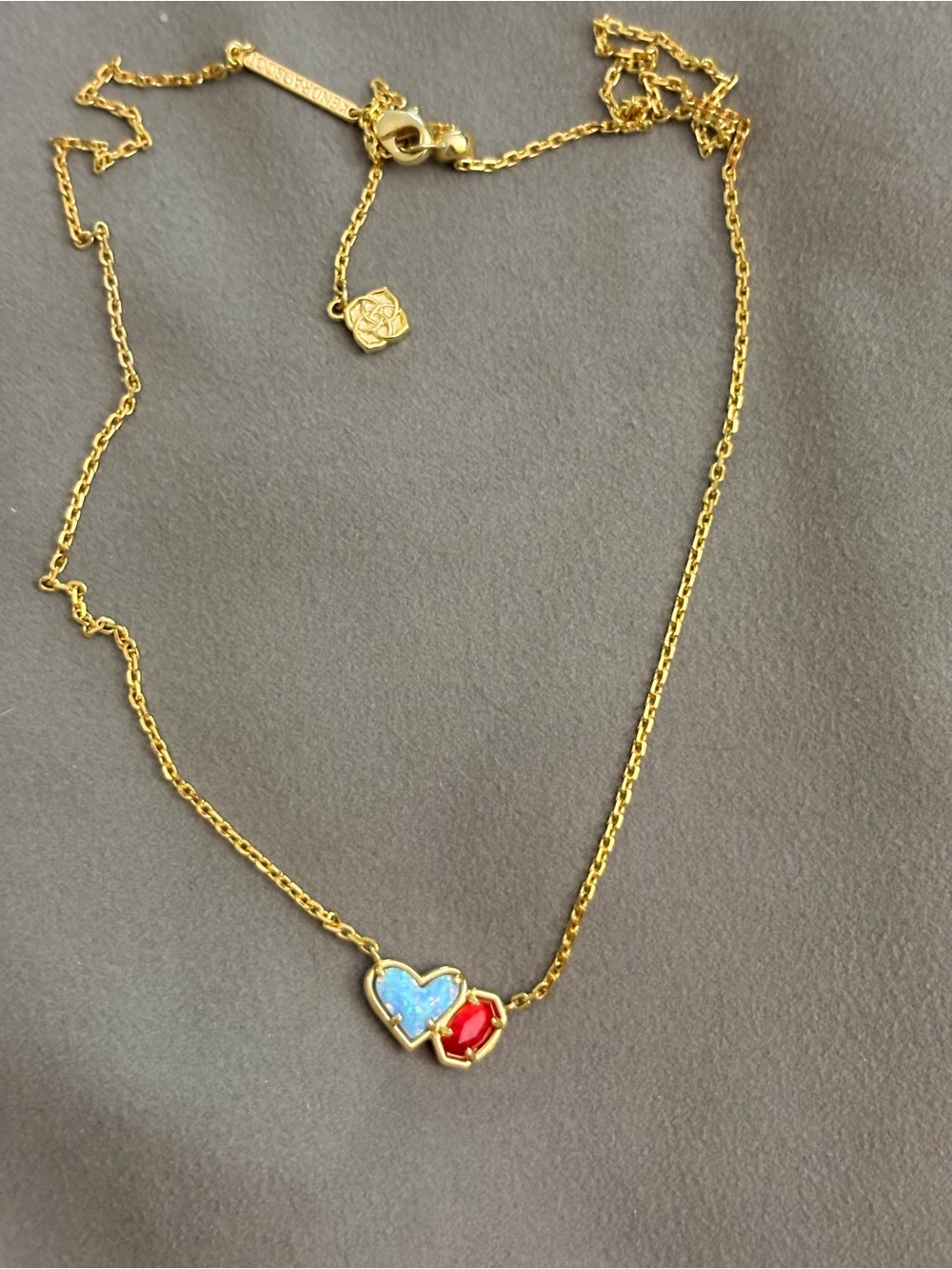 Kendra Scott Gold Necklace with light Blue opal heart and Red Stones